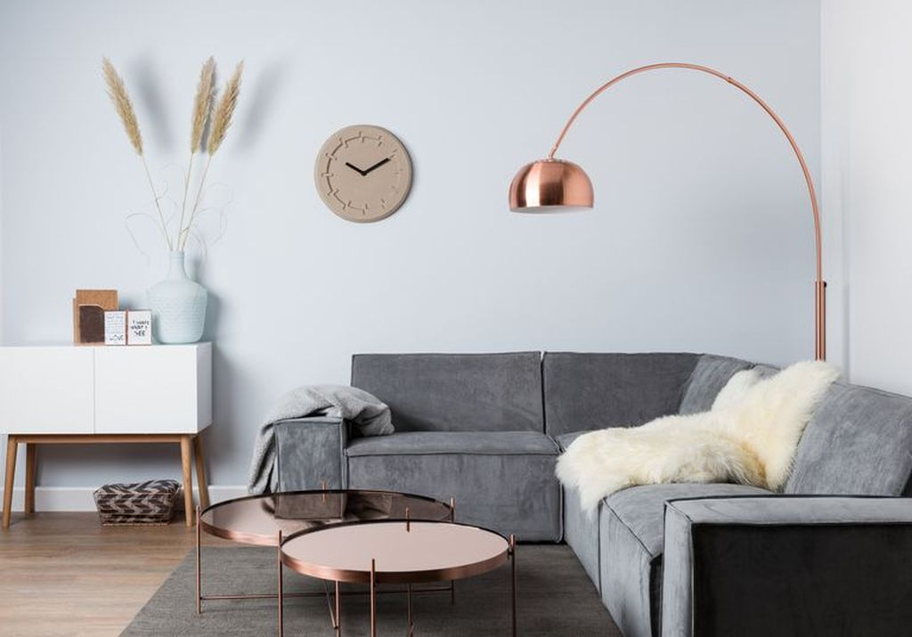An elegant living room design with copper floor lamp and round copper table to perfect your living room design