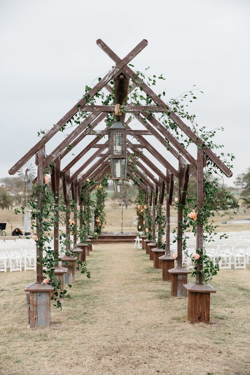 An exciting outdoor venue for fall wedding with this romantic rose-covered wooden archway perfect for walking down the aisle your wedding.