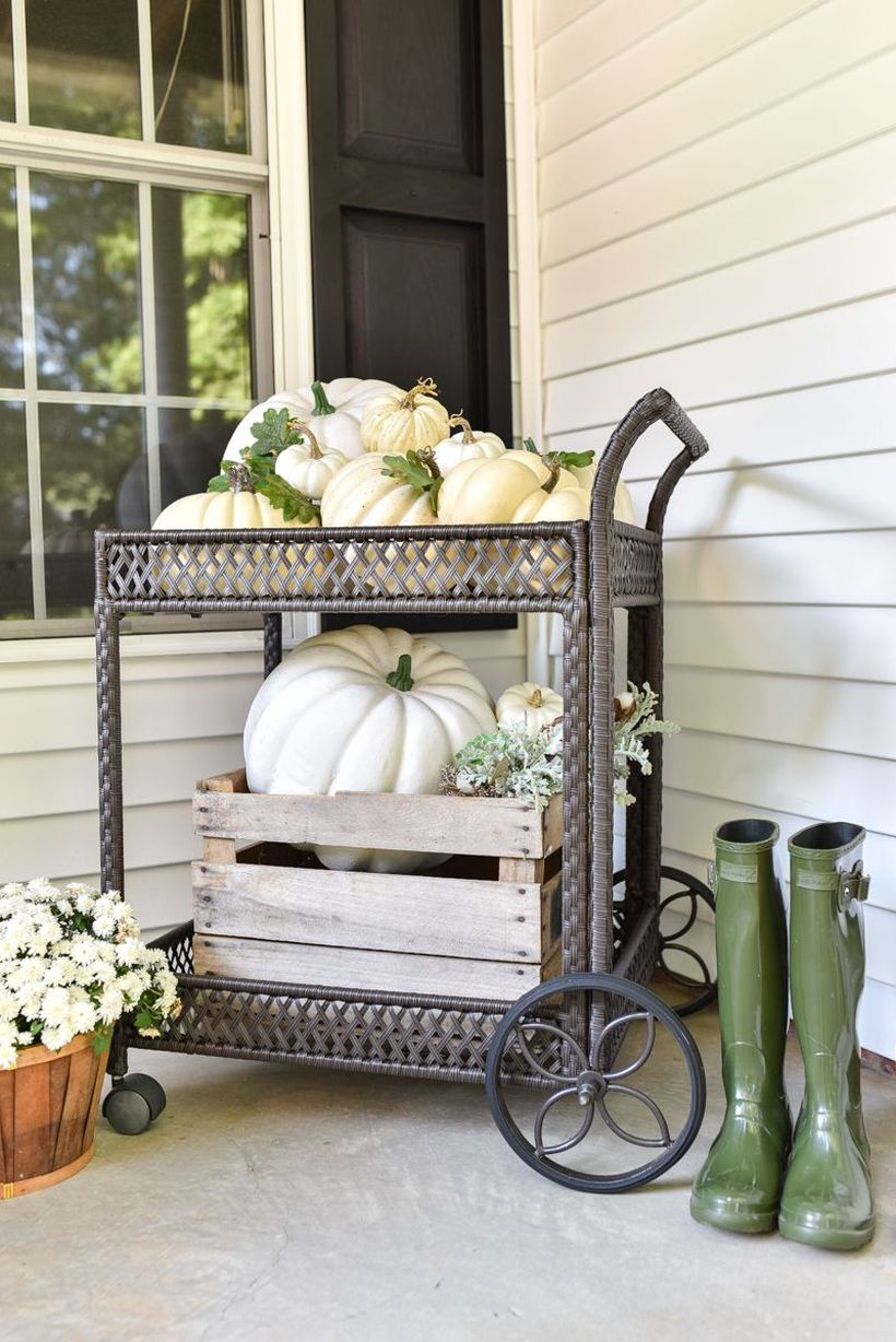 An impressive outdoor redecoration from summer to fall with pumpkins cart and shelf add more flair by interspersing a bit of greenery.