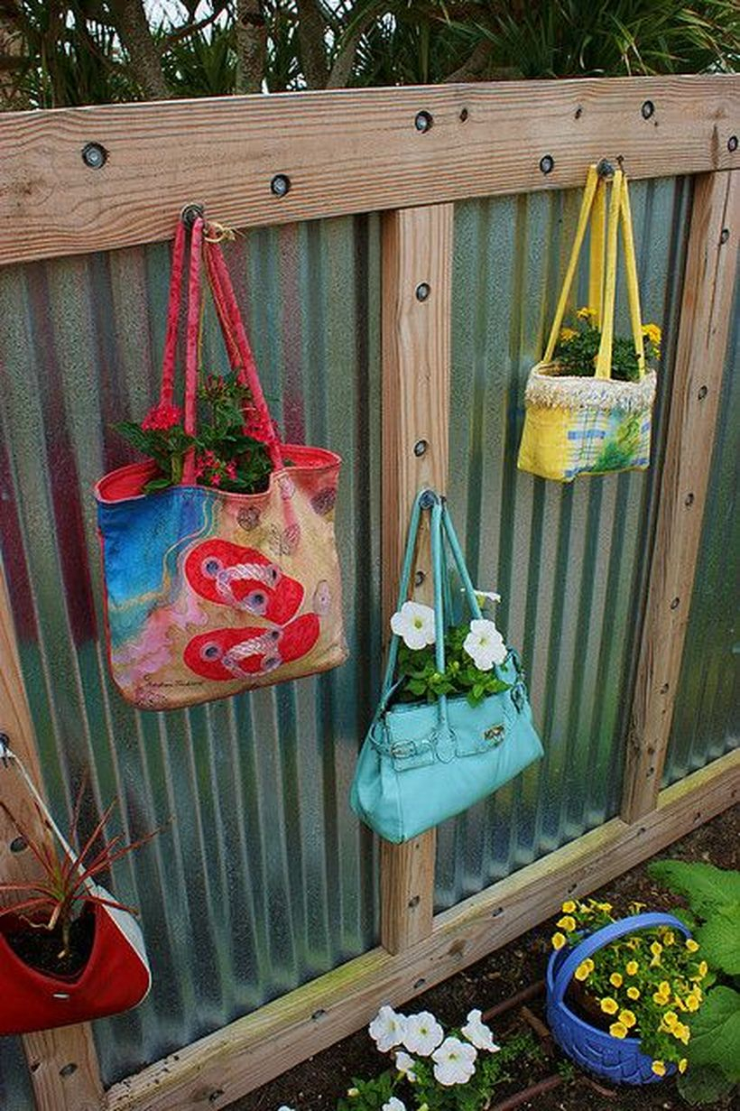 An incredible plant decoration for fence with colorful bag, totes lunch bags into beautiful planters for fence line the bags with plastic to keep soil from staining the fabric.