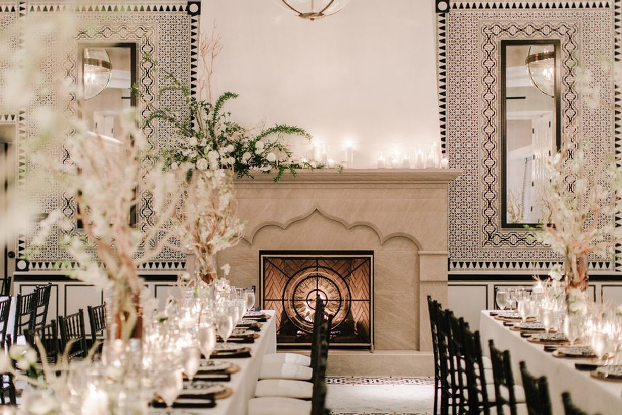 An interesting indoor table set for wedding with black and white tablescapes,black chairs and centerpieces to give you a calming wedding.
