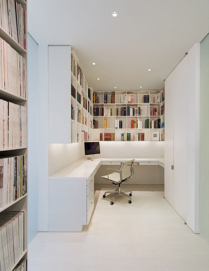 Stunning home office featuring white bookshelves and has white floors, white walls, a white desk with drawers to perfect your home office