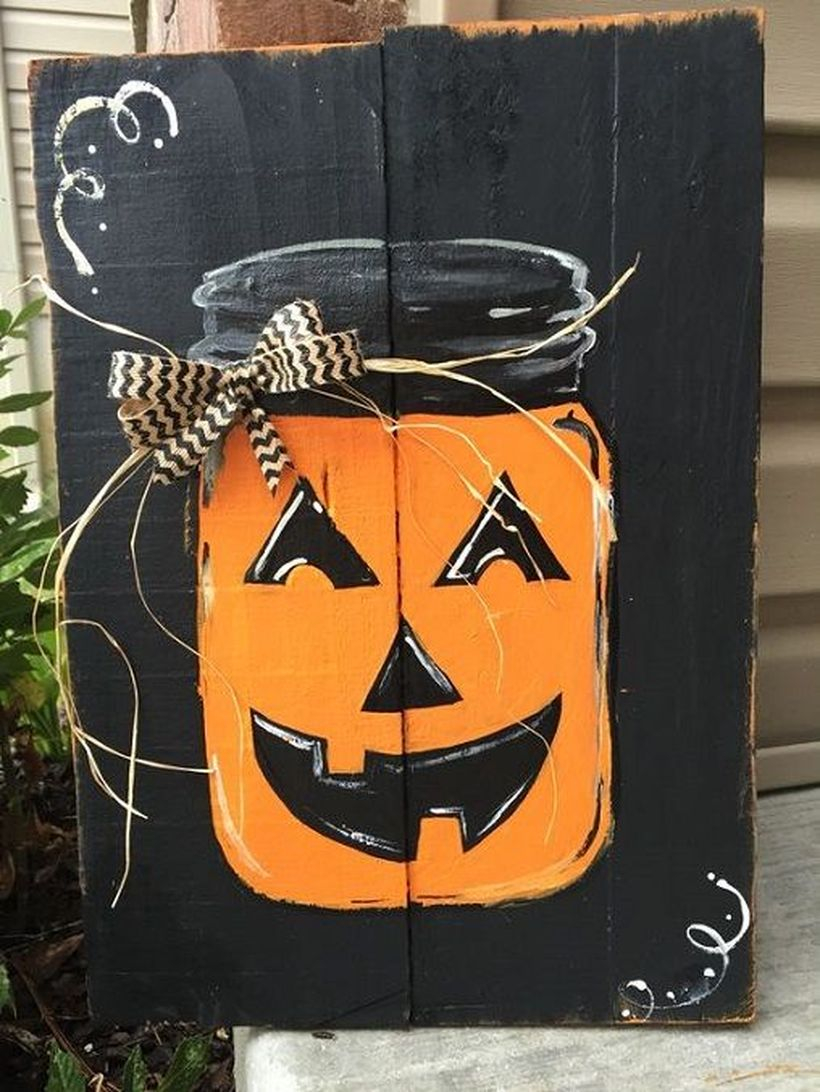 A creative painted a mason jar on a pallet