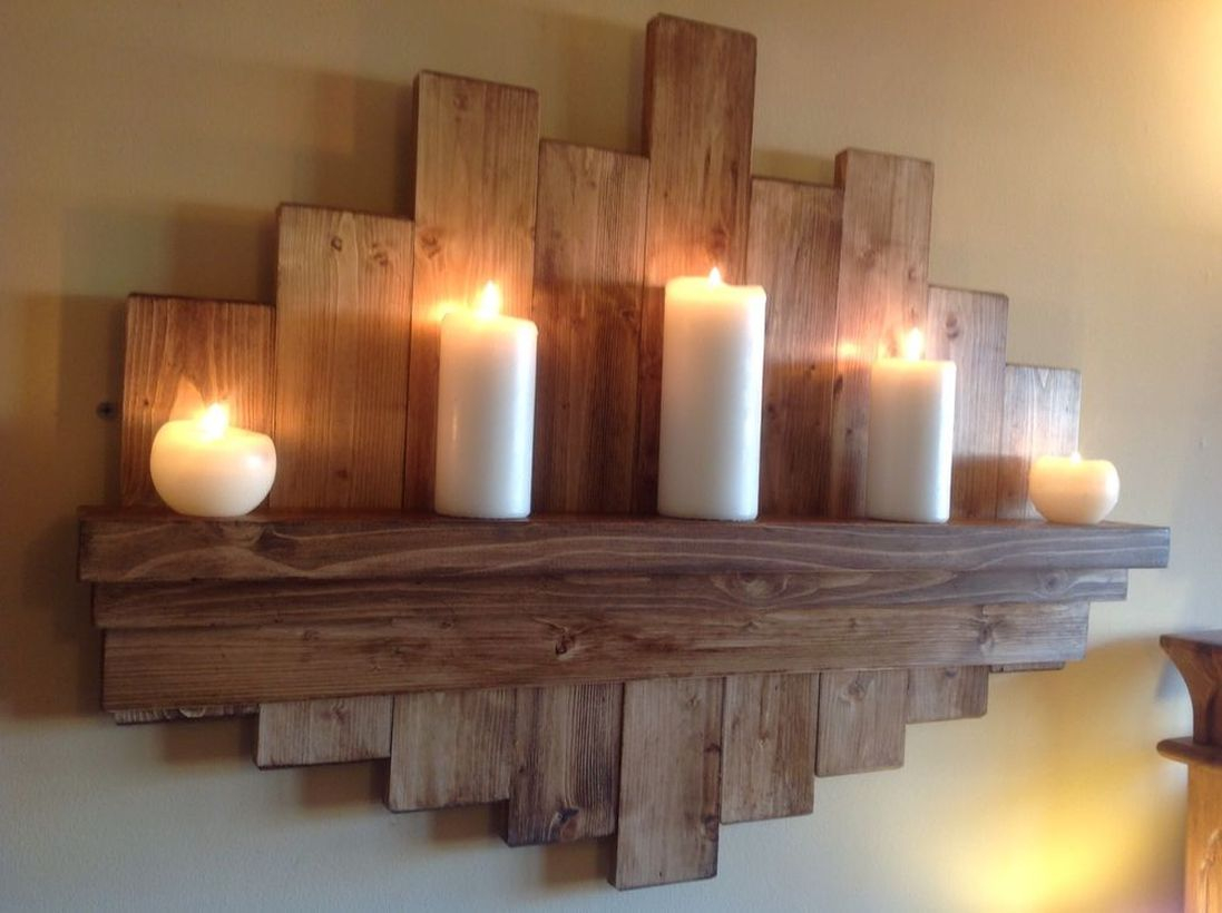 A creative rustic wall art ideas with hanging rack to store candles to create good lighting