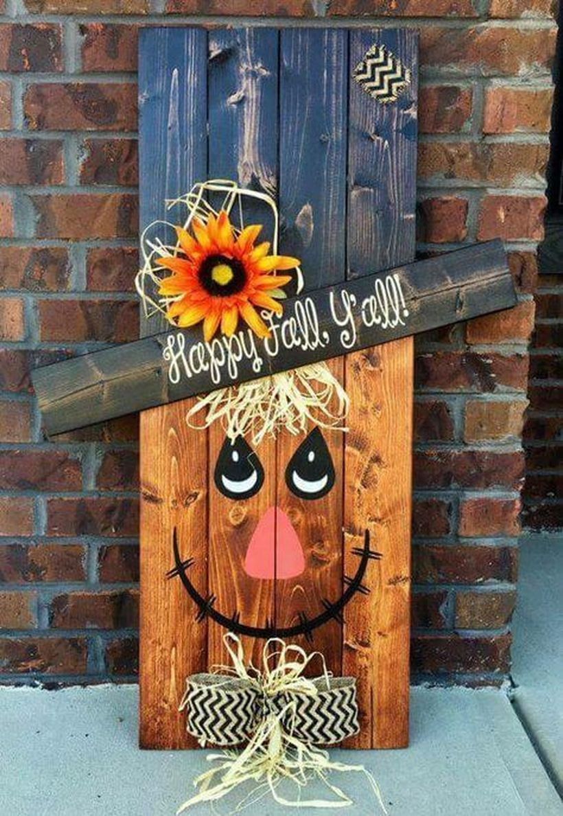 An adorable scarecrow with the saying, “happy fall y'all” for your porch