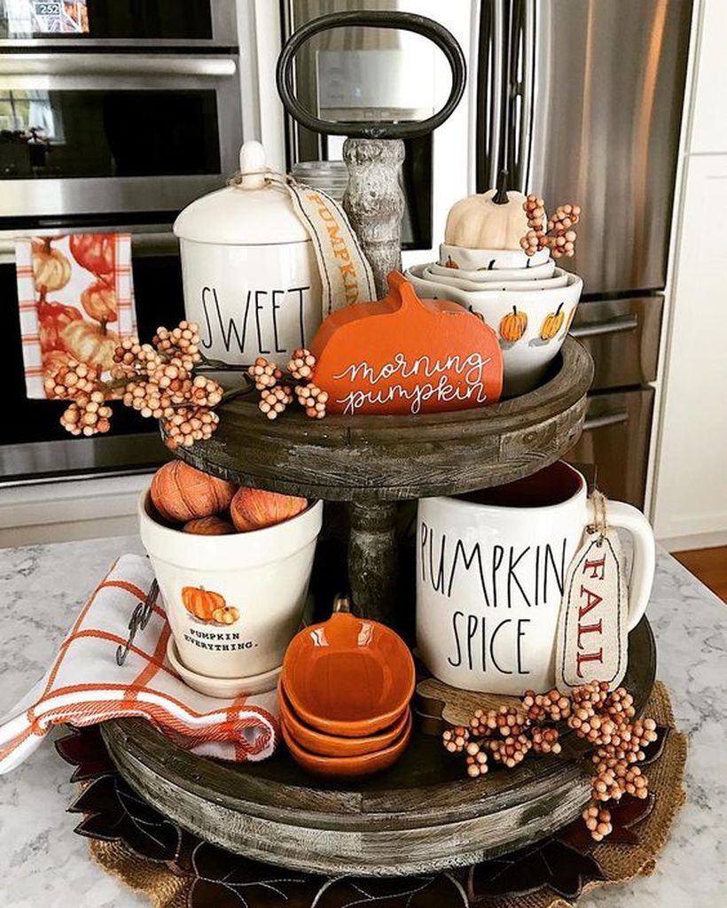 An inspired little pumpkin and white cup coffee using for centerpiece decoration in kitchen