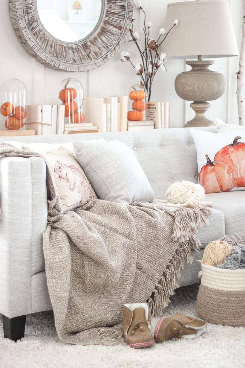 An interesting living room decoration with pumpkin decoration in jar and sofa cushions pattern pumpkin to look a cozy room