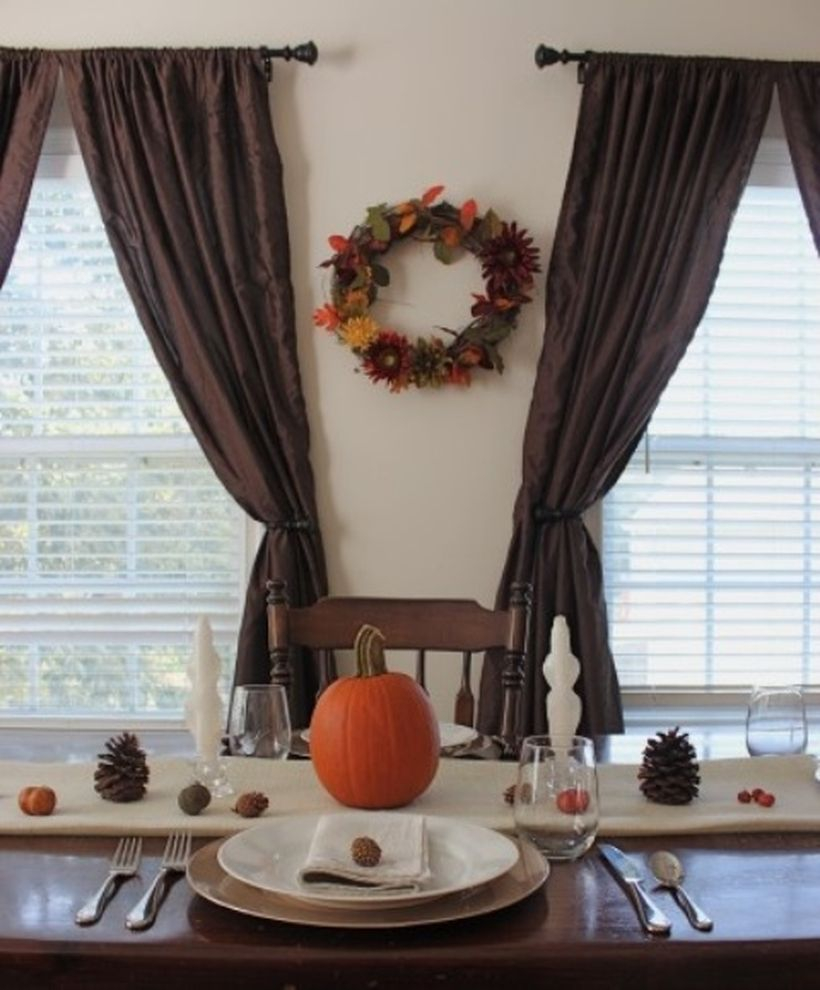 Cozy fall dining room decor ideas with pumpkins on dining table to create a your good mood