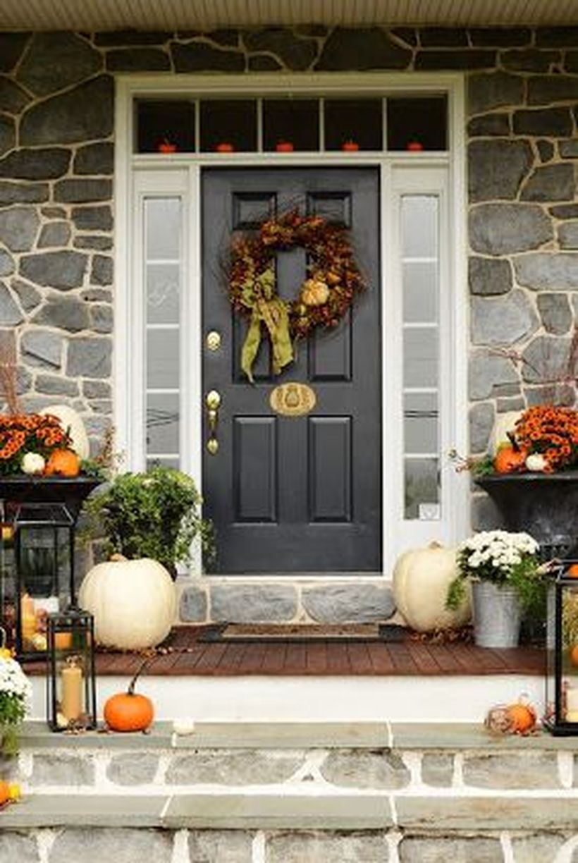 Fall porch decorating ideas with white and orange pumpkins decoration and pumpkin wreath you must try