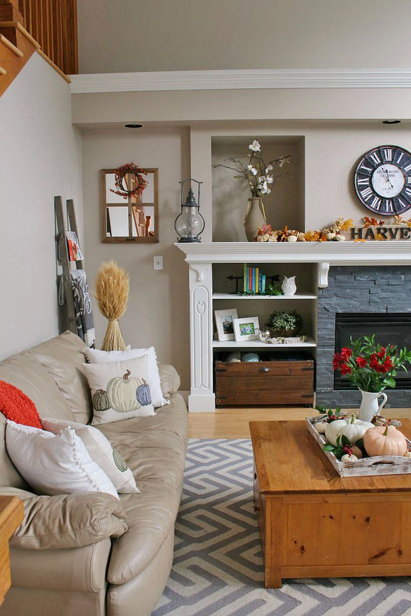 Simple living room decoration with pumpkin decoration on coffee table, houseplants and modern fire pit you must try