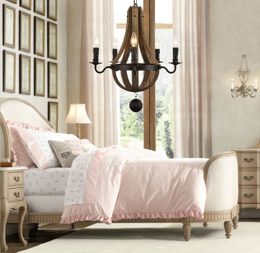 A fabulous rustic chandelier for bedroom with rustic wooden pendant chandelier, thick blanket, large carpet, fireplace, big windows, long white curtain and decoration on the wall.