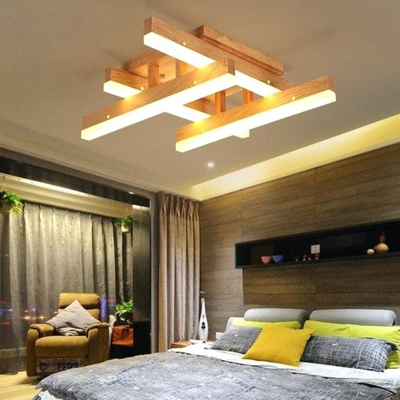 A gorgeous rustic chandelier for bedroom with worldwide delivery wood chandelier, thick blanket, a yellow chair, big window and long curtain.