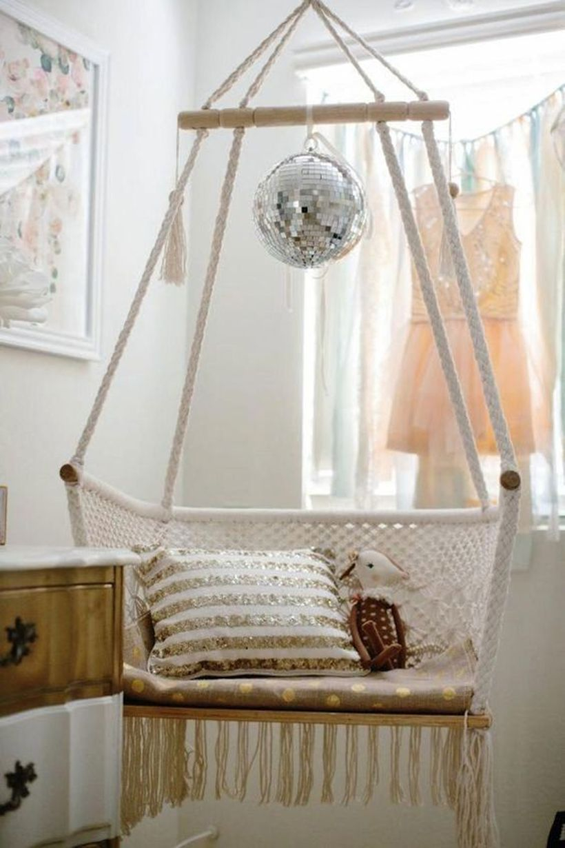 A hanging macrame chair for a kids' room.