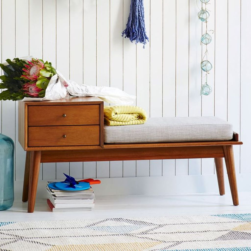 An amazing mid-century storage bench with wooden material to complete your entryways decor