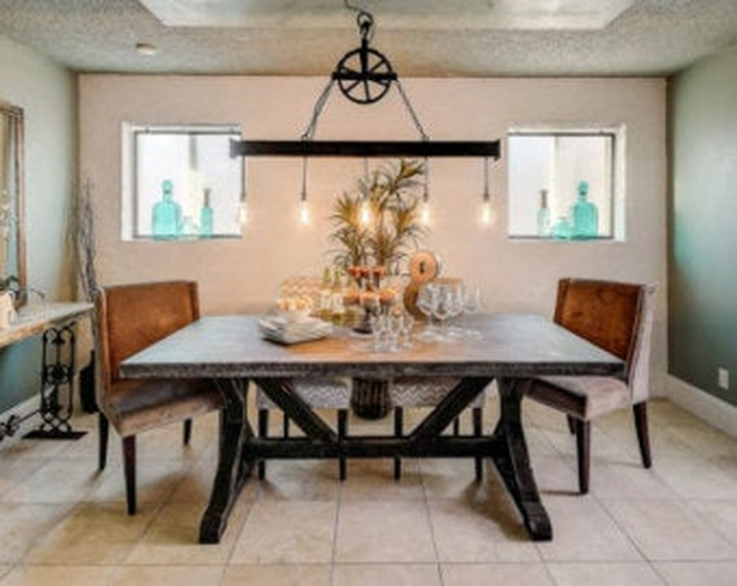 An awesome rustic chandelier for dining room with pendant chandelier, large table, leather chairs, small windows and decoration on the table.