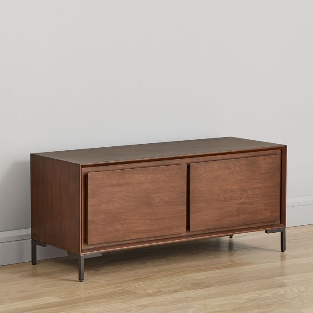 An awesome wooden bench with two storage cabinets below it to organize your entryway decor