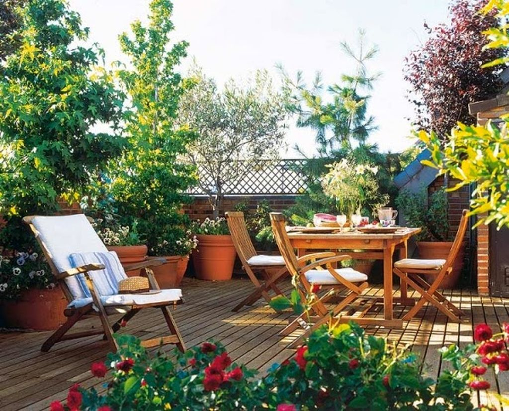 Beautiful large rooftop design combined with wooden floor, wooden furniture combined with plants around it to complete your rooftop design