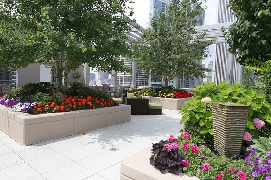 Beautiful rooftop garden design with colorful flowers combined with grow trees, shrubs, foliage plant and annuals for a burst of color