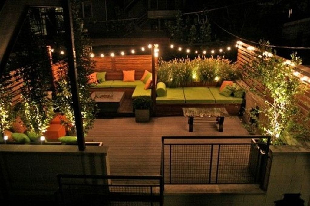 Beautiful small rooftop lighting by lights on edges and string light placed diagonally to beautify your rooftop garden