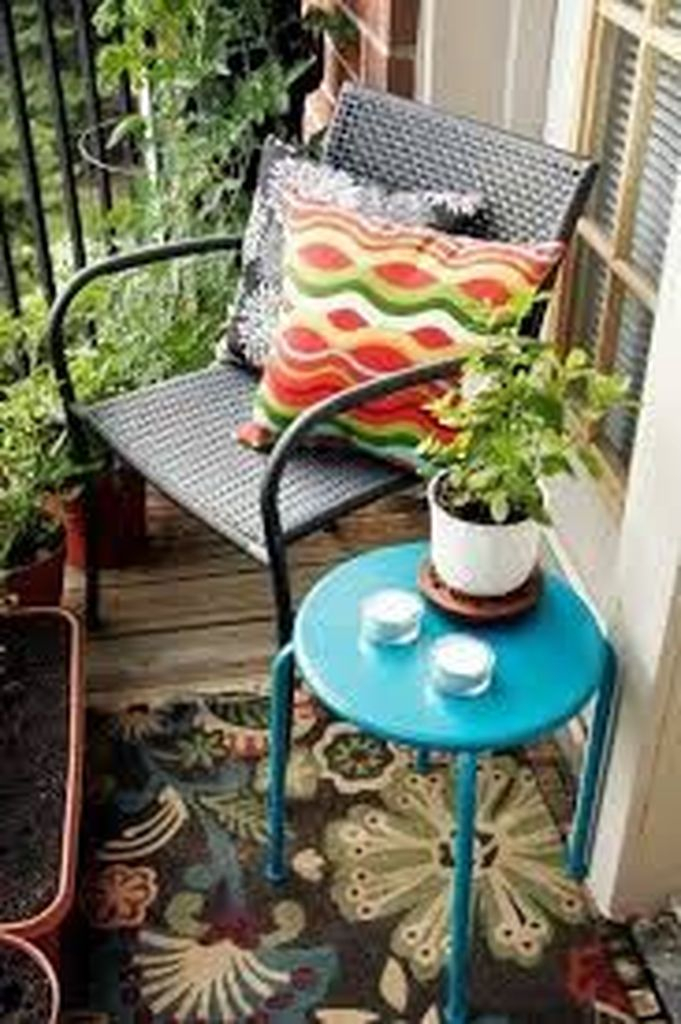Blue table combined with rattan cahair to perfect your small balcony