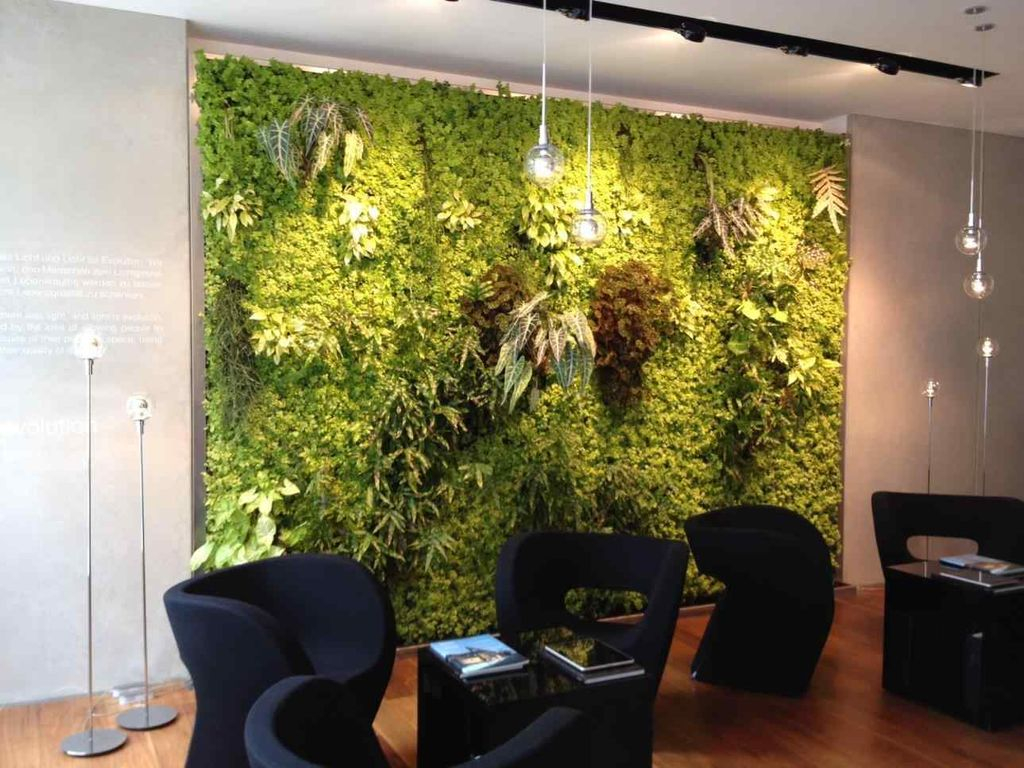 Captivating modern living room design with perfect lighting and dark seating combined with moss on the wall to perfect your living room design