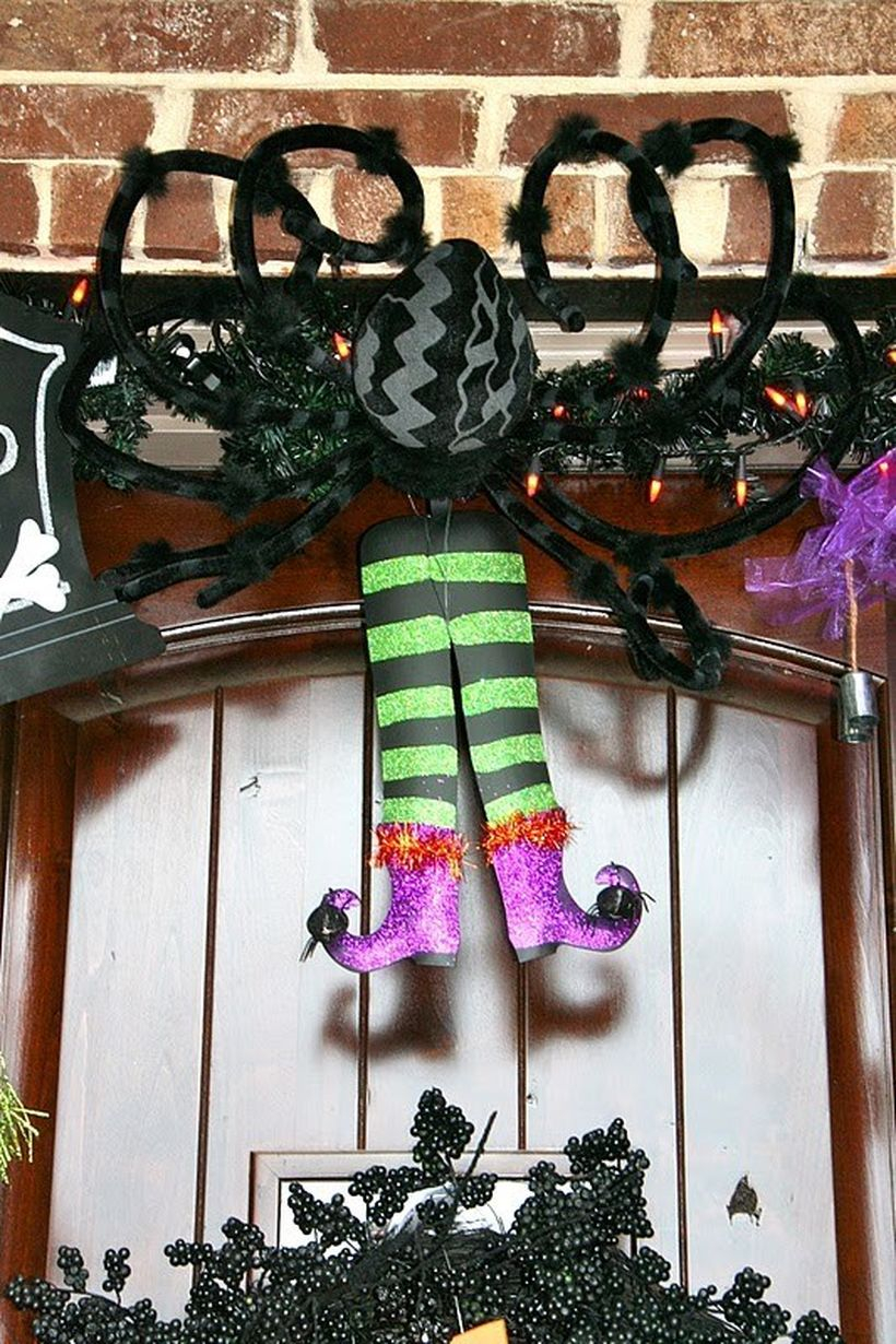 Comfortable witch-eating spider halloween door.