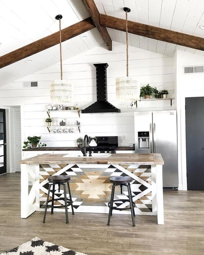 Cool boho kitchen decor with simple island patterned wooden table, hanging rattan lamps and white walls for good looking