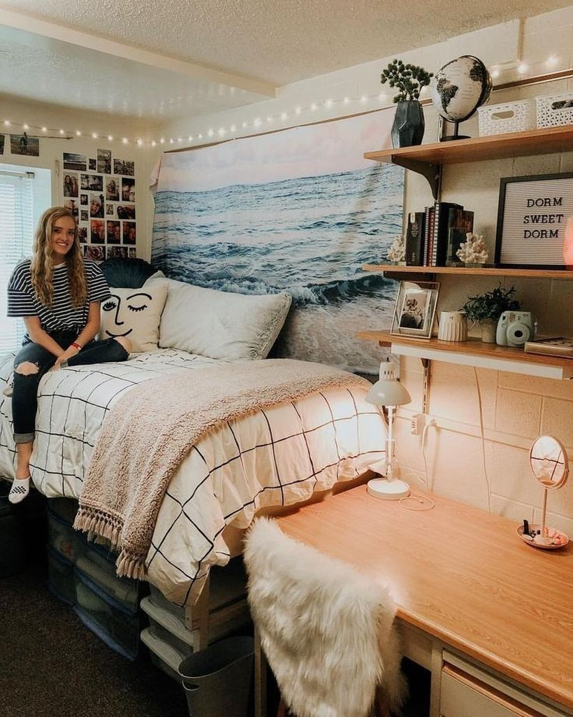 Cool girls room decor with white plaid bed, pink blanket, wall decorations made of fabric with pictures of the ocean and string lamps on the wall