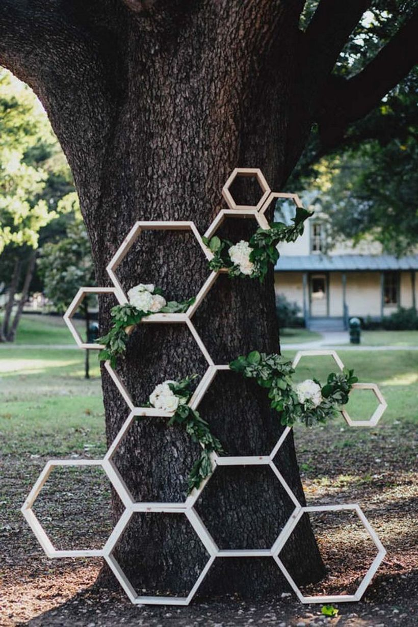Creative industrial geometric wedding decoration with tiered hexagon rack to store white rose in outdoor