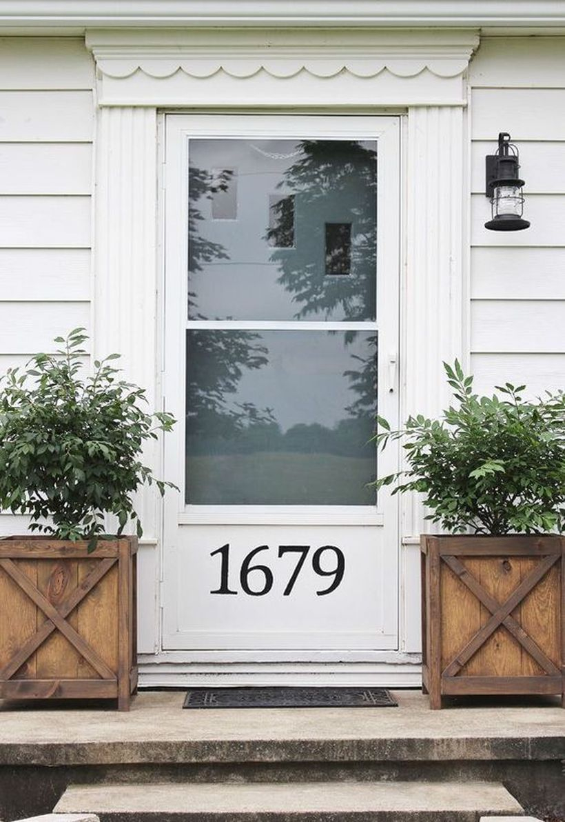 Front door decoration with small tree in wooden box for a vintage farmhouse feel