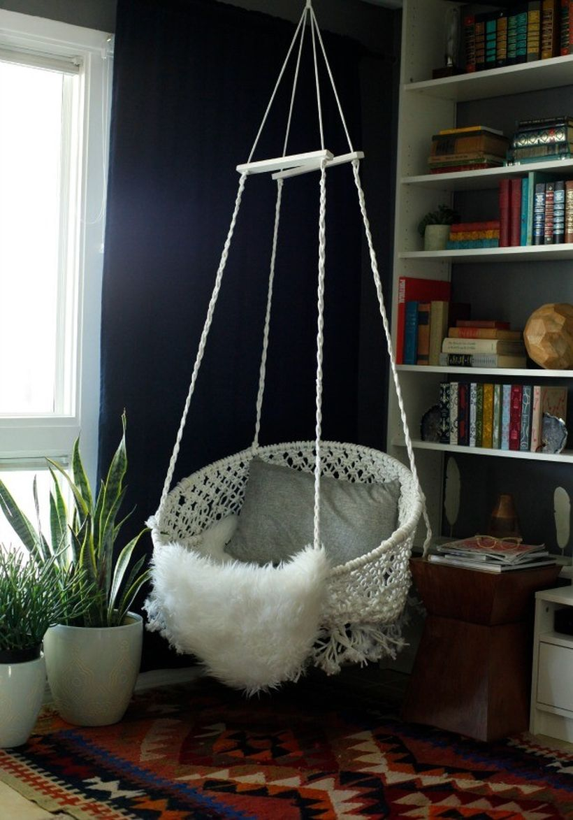 Hanging delicate white macrame chair.