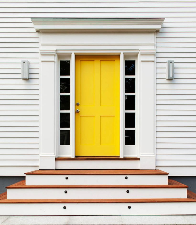 Inspired front door decoration with a vibrant yellow front door for a traditional home