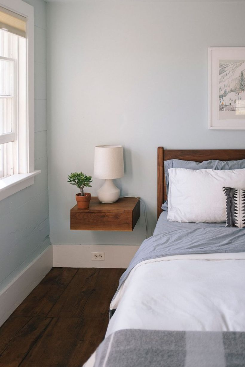 Interesting succulent with green pot on the small wooden table to decorate your bedroom