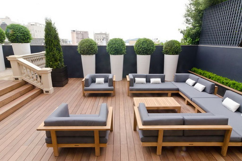 Modern rooftop garden design with grey sofa combined with wooden floor to beautify your rooftop garden design