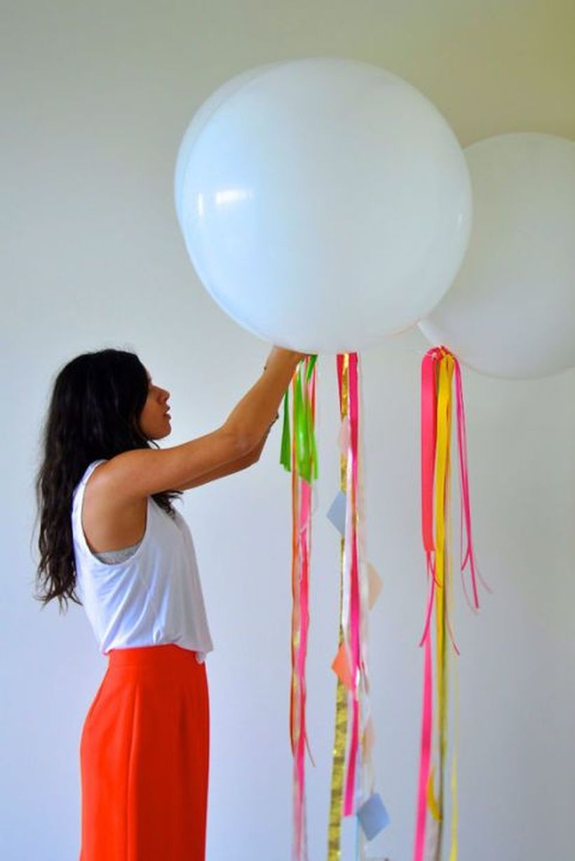 Ornament birthday party decoration with balloons then add ribbons to make it more interesting