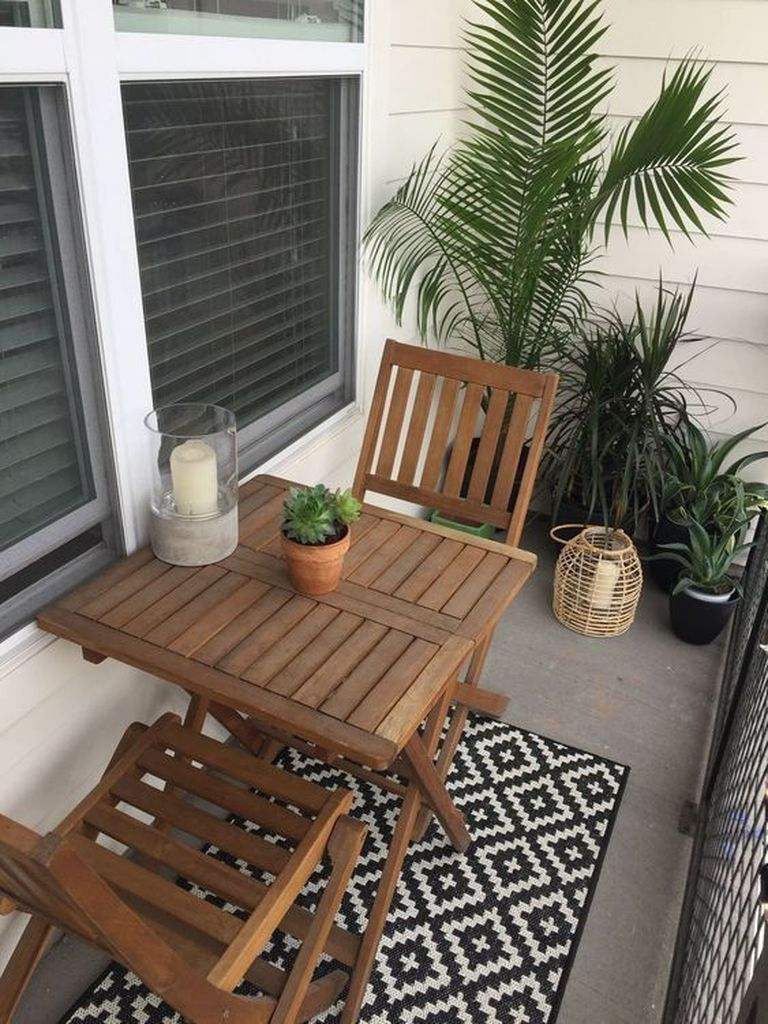 Patterned rug combined with wooden table and chair for balcony