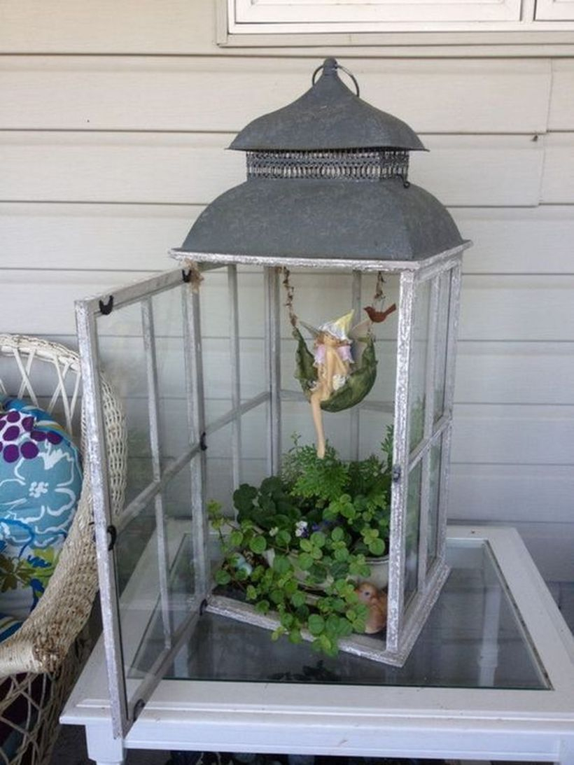 Rustic lantern terrarium with white wooden lantern, greenery, and small fairy for your home decor
