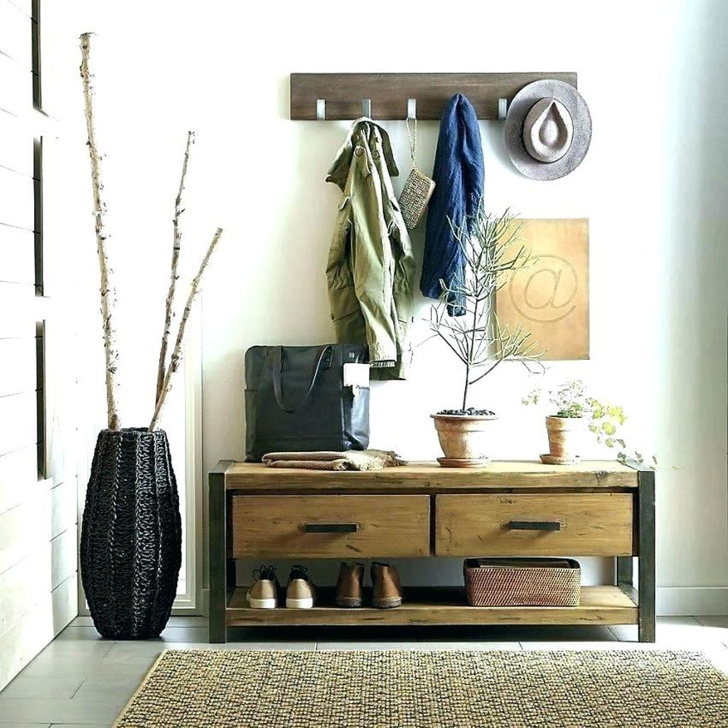 Rustic entryway with coat hooks above mudroom bench to perfect your entryway decoration