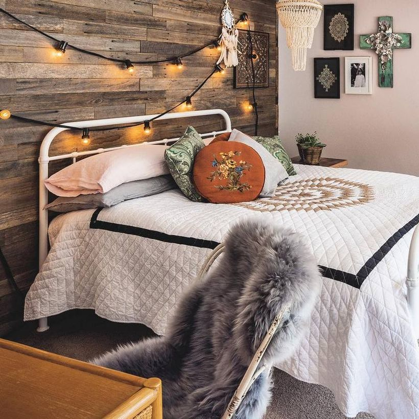 Simple boho bedroom style with white blanket pattern simple, white and gray pillows, wooden walls are equipped with string lamps to look creative decoration