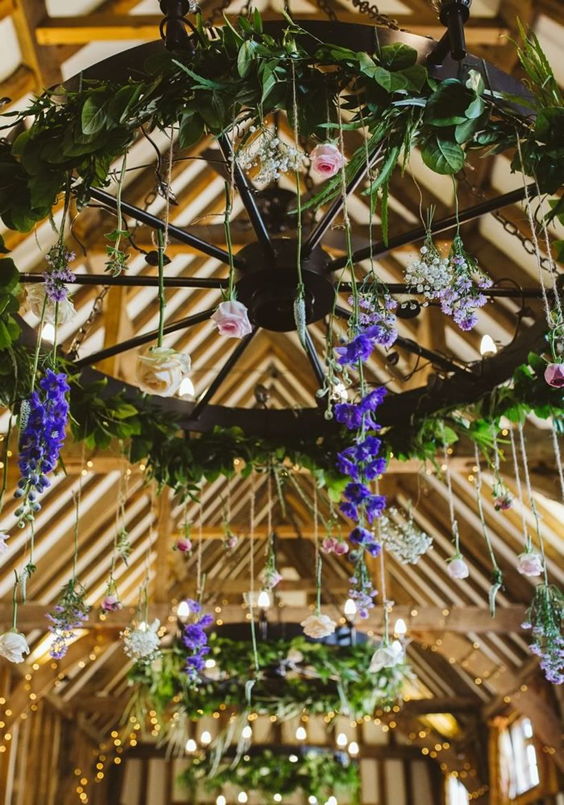 Venue wedding decoration with trailing flowers and foliage wreaths to create whimsical suspended centrepieces to create a fancy