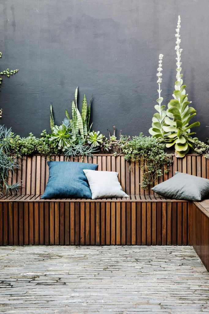 Wooden bench combined with plants and cushion