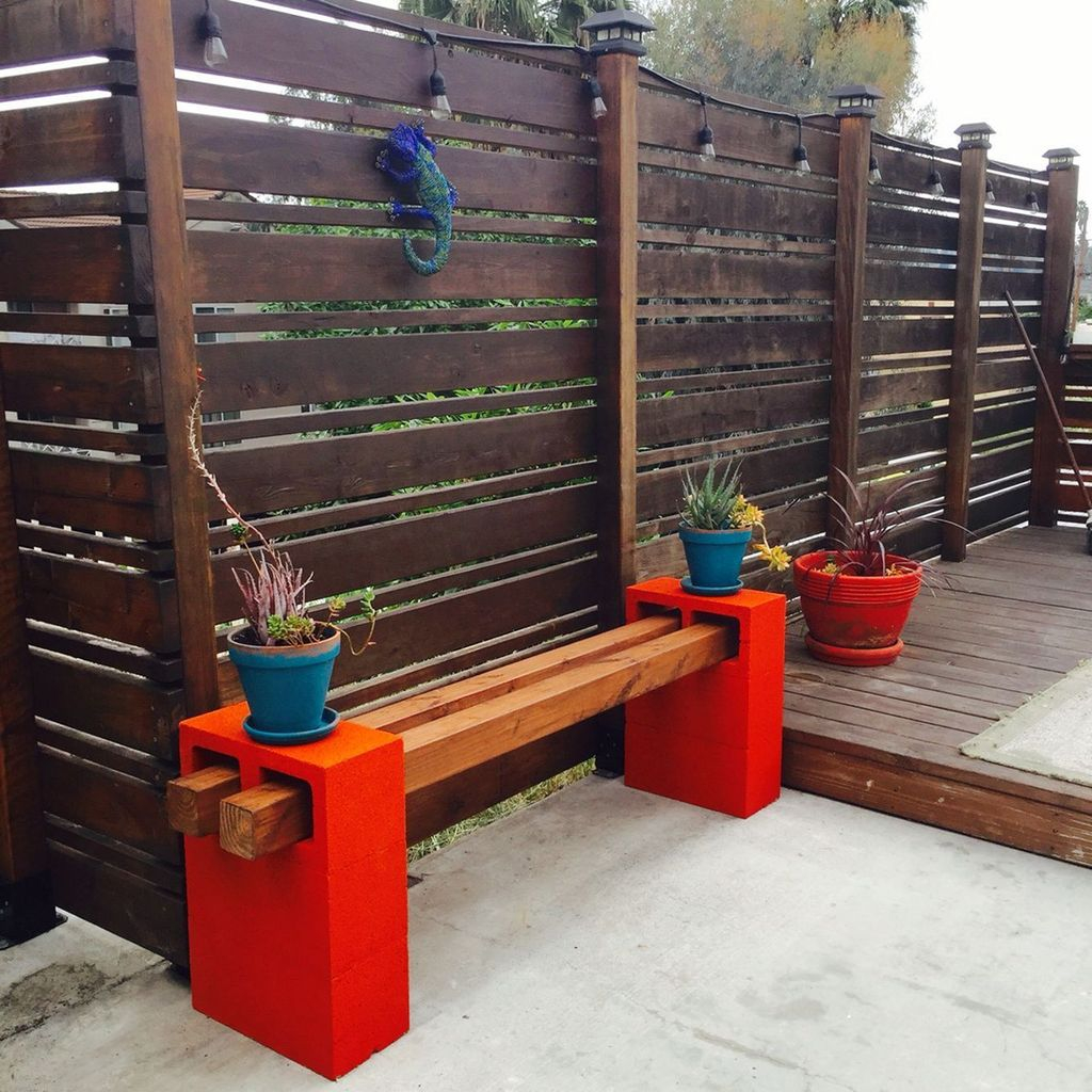 Wooden bench with red stand to perfect your garden