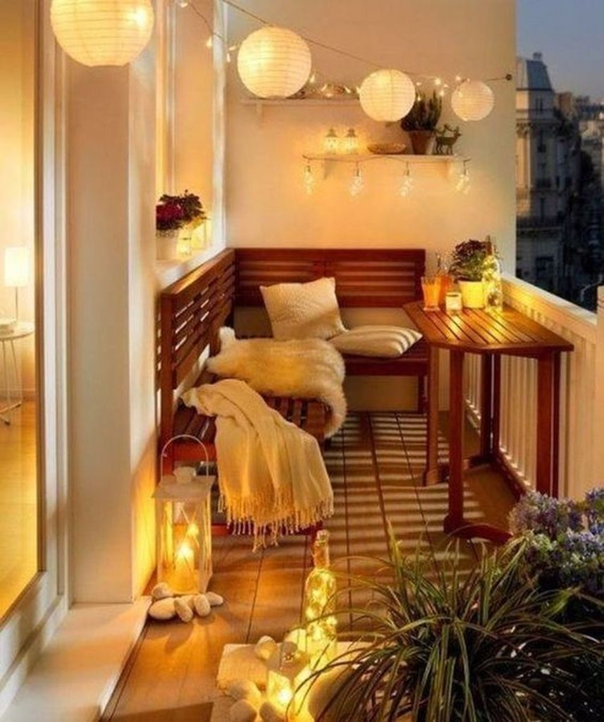 Wooden cahair combined with perfect lighting to perfect your balcony