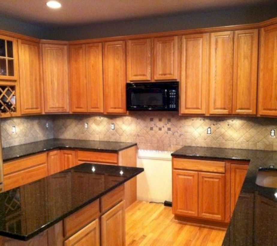 Black marble countertop design on brown wooden cabinet