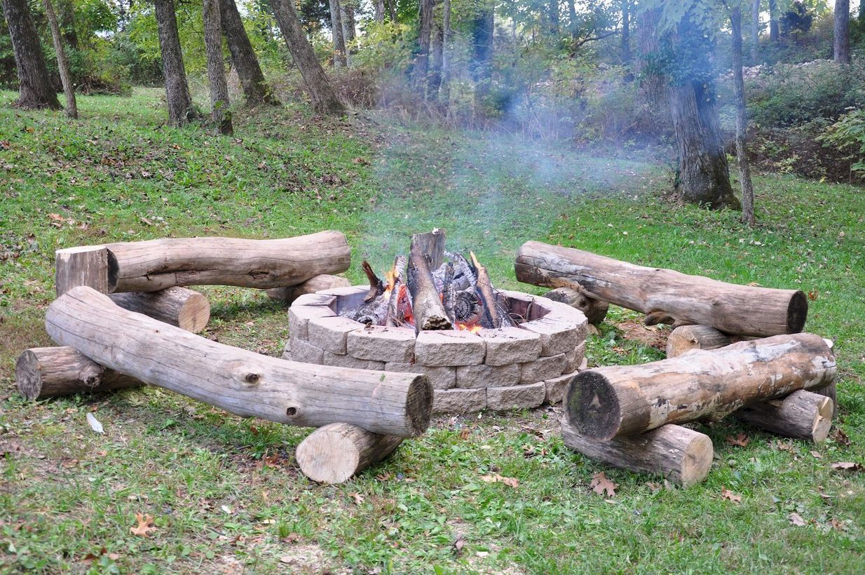 Circle fire pit with tree cut to sit