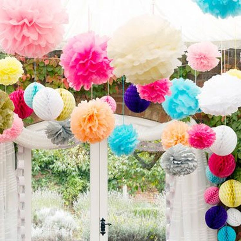 Creative paper carft with pom pom shape then hung to decorate a birthday party
