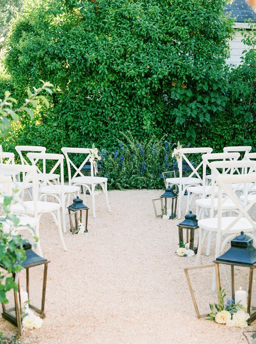 Decorative candle in lanterns and white chair for wedding outdoor