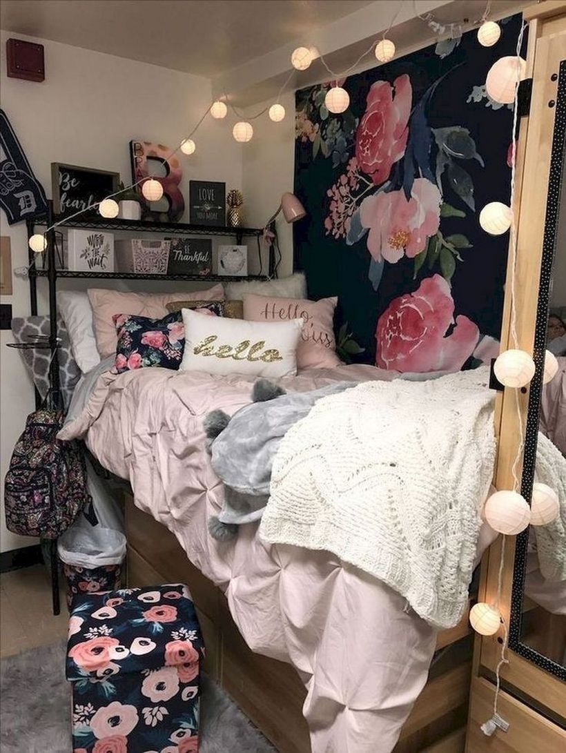Fabulous girls room decoration with pink blankets, beige and white pillows, black storey storage above the bed, wooden storage under the bed and small round string lamps