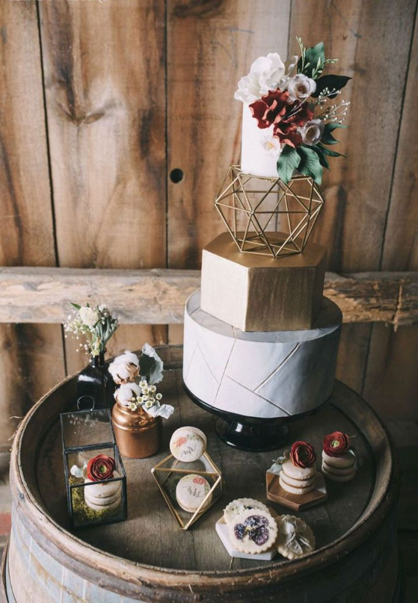 Gorgeous boho inspired wedding cake with flowers and rose gold modern geometric details