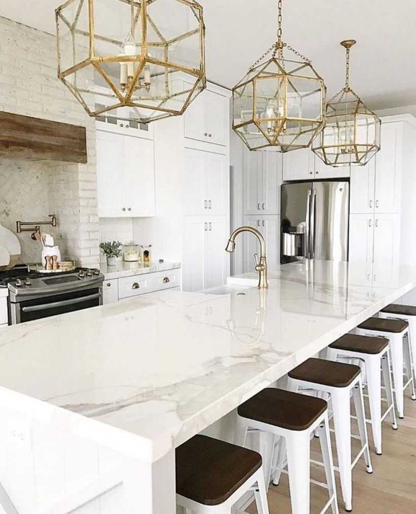 Long square white countertop design with white and black chairs